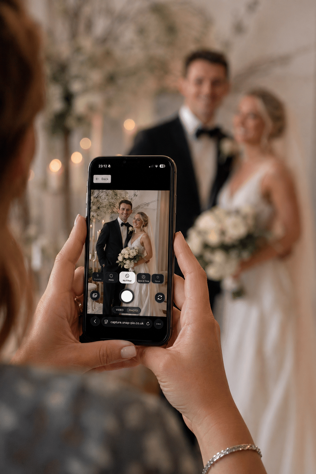 Wedding couple being photographed with a smartphone